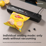 Black bar vacuum sealer on a counter sealing a bag of crisps in the seal only mode without vacuuming