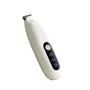 White cordless pet grooming trimmer angled to show the stainless blade and the lit power and charge indicators
