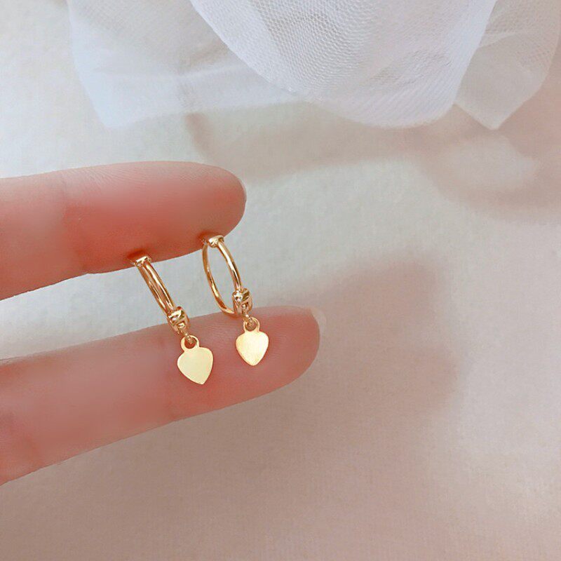 Heart ear cuff against a clean off-white studio background