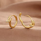 Gold nail stud earring shown from the side with its straight post and back