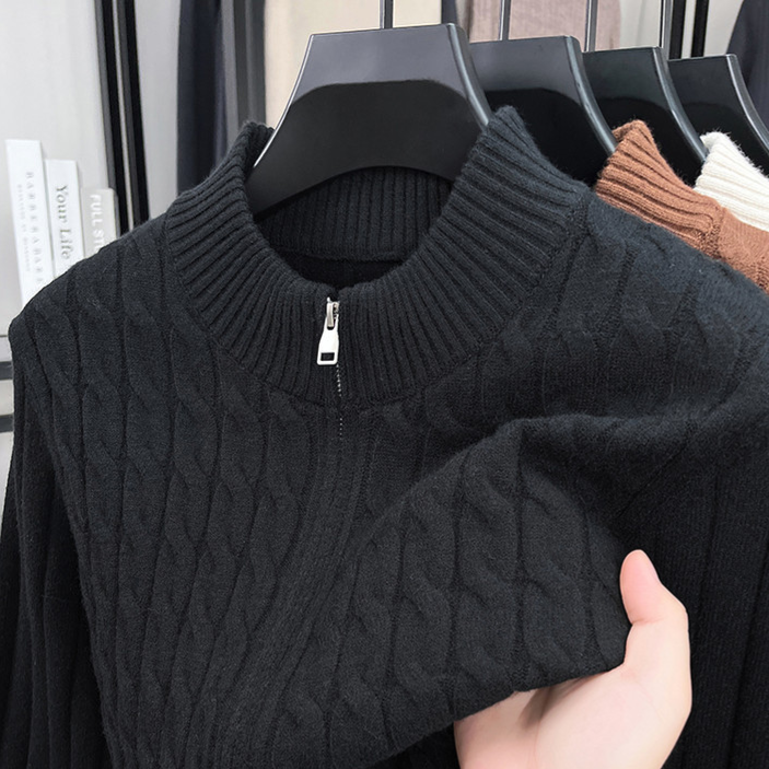 Black thick cable knit half zip sweater with a stand collar and neck zip