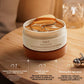 Open jar of LAO LI SHI eye mask with one amber patch lifted beside a silver beauty tool, marketing text overlay