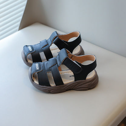 Closed toe baby sandals in soft studio light showing leather look texture detail