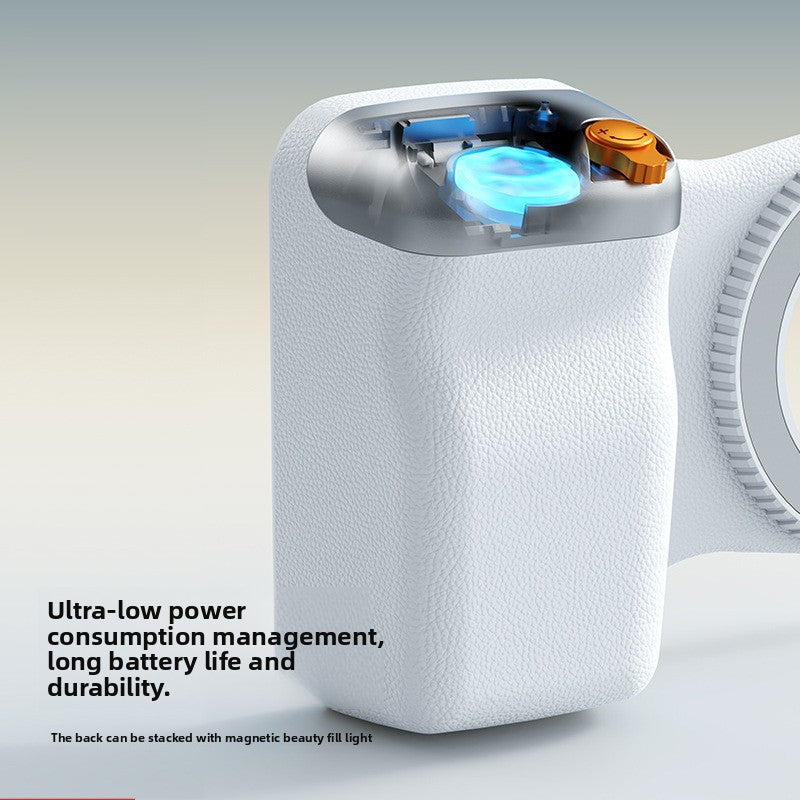 Cutaway view of the white phone grip showing its coin cell battery and buttons