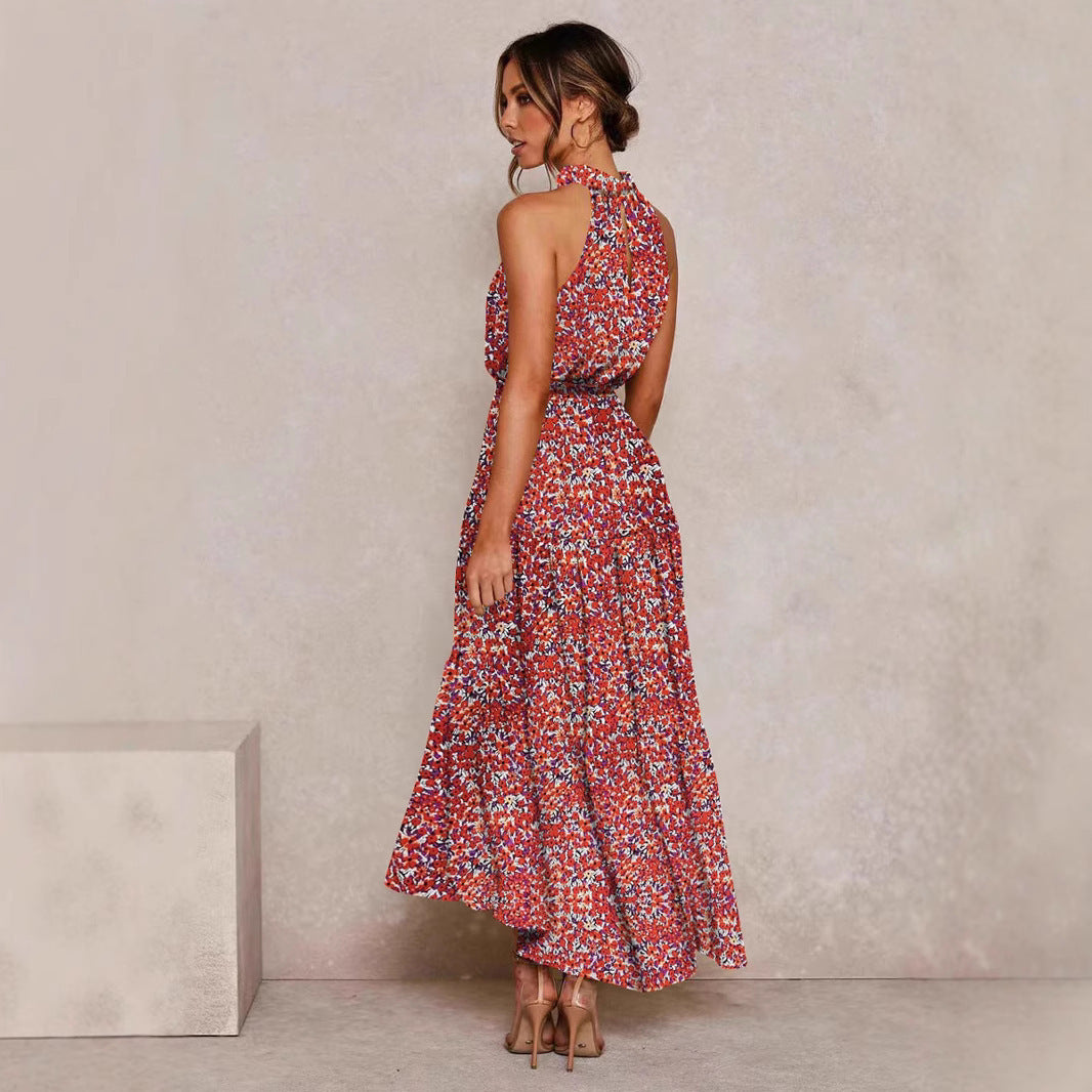 Pink and red floral halter neck sleeveless tiered swing maxi dress worn by a model