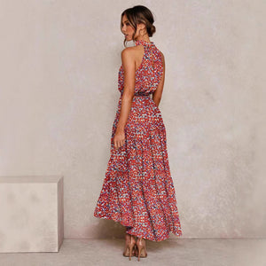 Pink and red floral halter neck sleeveless tiered swing maxi dress worn by a model