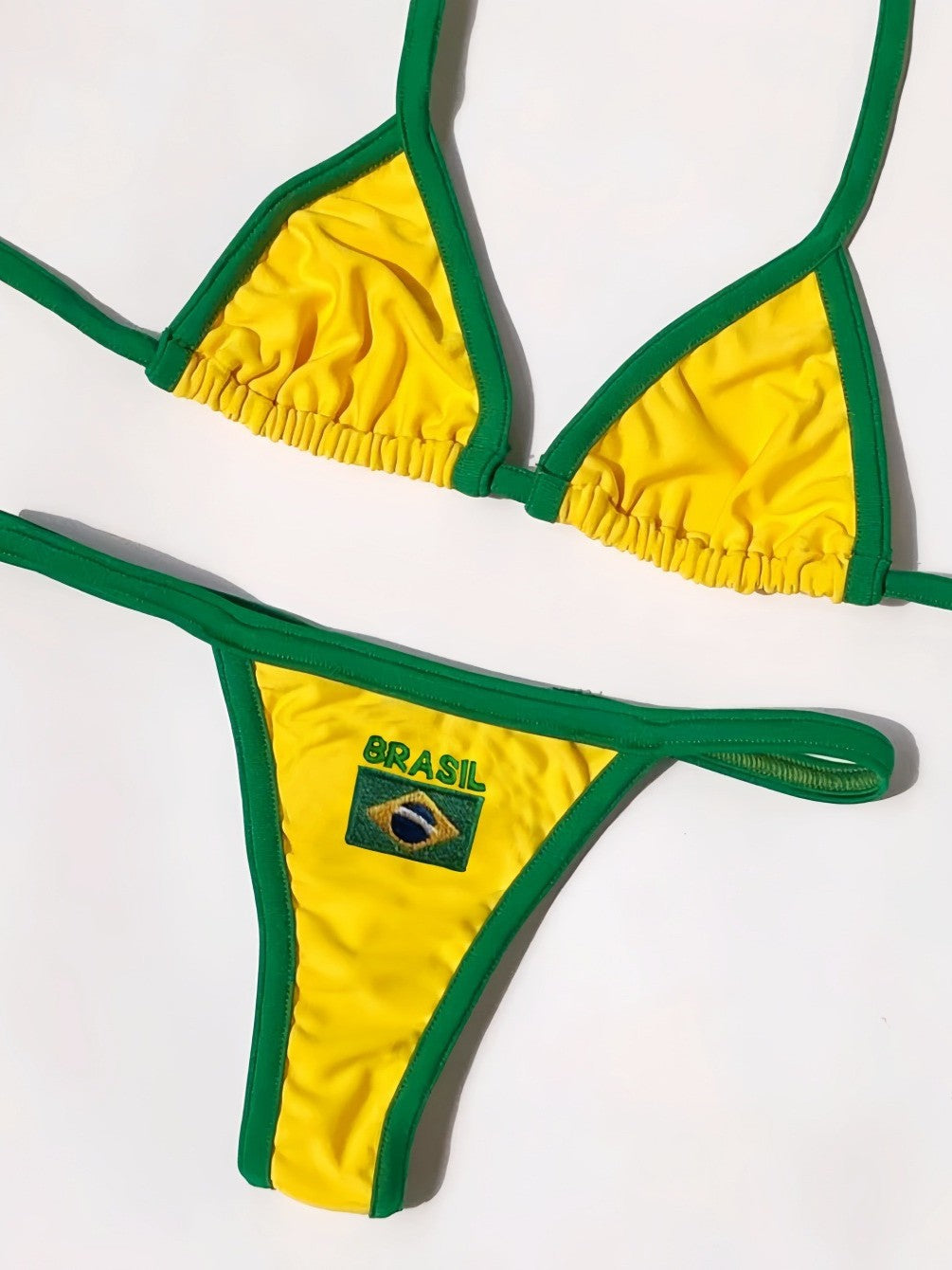 Yellow and green Brasil thong bikini set laid flat on white
