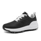 Top-down view of a pair of breathable lace-up golf shoes with mesh detailing