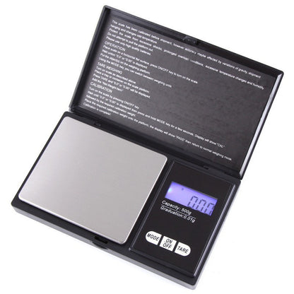 Open black pocket digital scale with a stainless steel platform and a blue backlit display reading 0.00, 500 g capacity
