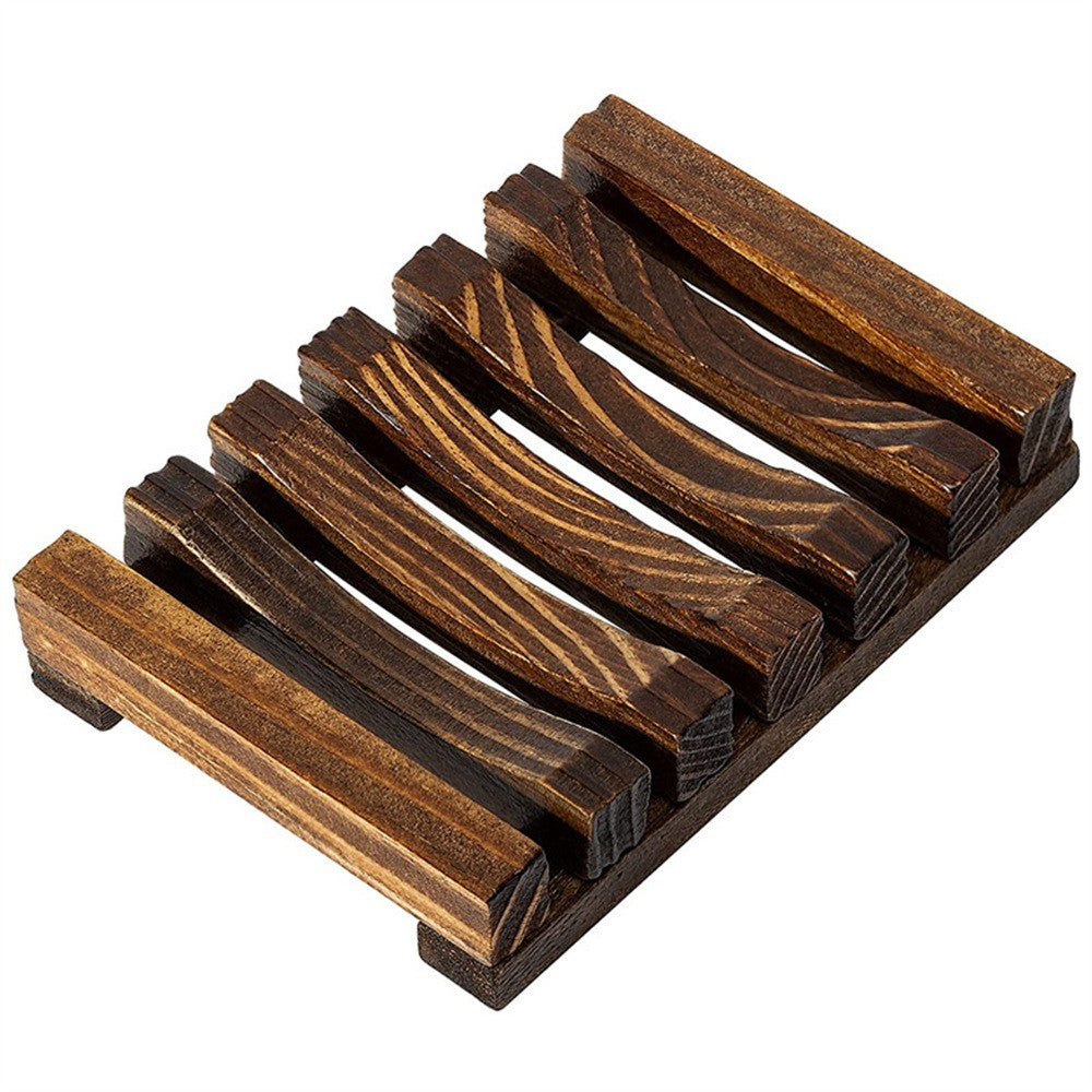 Dark charred pine wood slatted soap rack with side rails on a white background