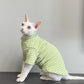 Green and white striped cat shirt on a seated hairless cat, side view, sixth green option photo