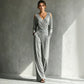Ruched waistband joining the wrap bodice to the wide-leg pants of the jumpsuit