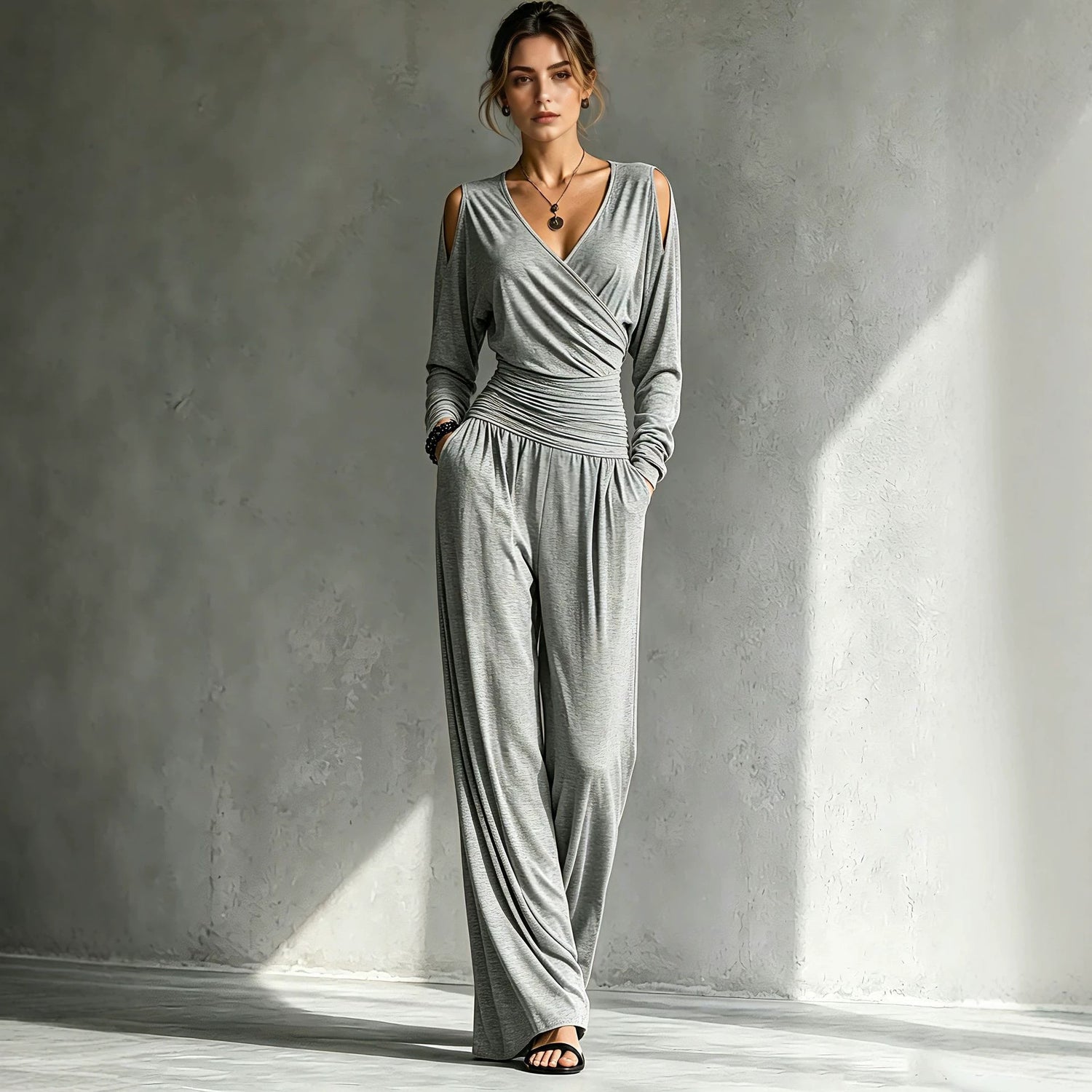 Ruched waistband joining the wrap bodice to the wide-leg pants of the jumpsuit