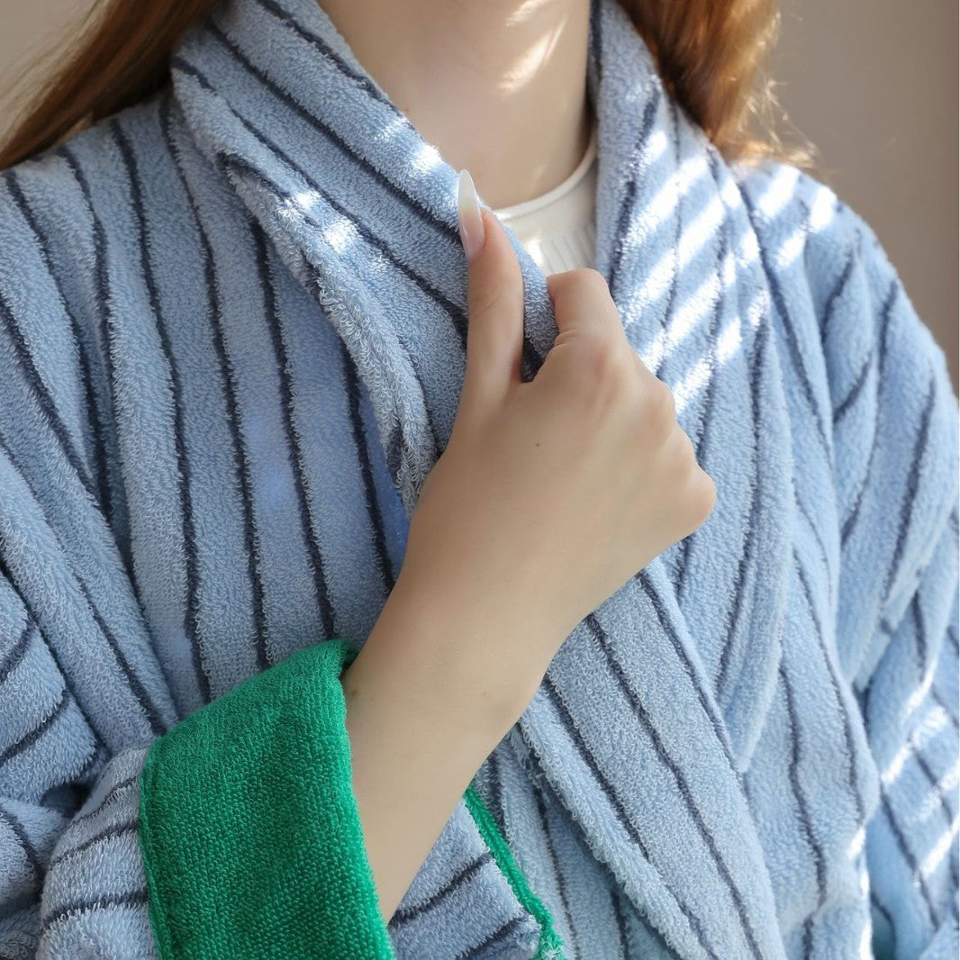 Close view of a blue striped cotton terry bathrobe collar with green trim and looped pile