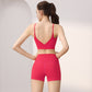 Back view of a woman in a pink V-back sports bra and high-waist shorts set, size M option