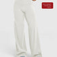 Curved back seam high waist wide leg pants on a standing model