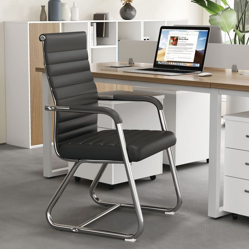 Low back black leather cantilever conference chair, foam seat, fixed armrests and chrome frame in an office