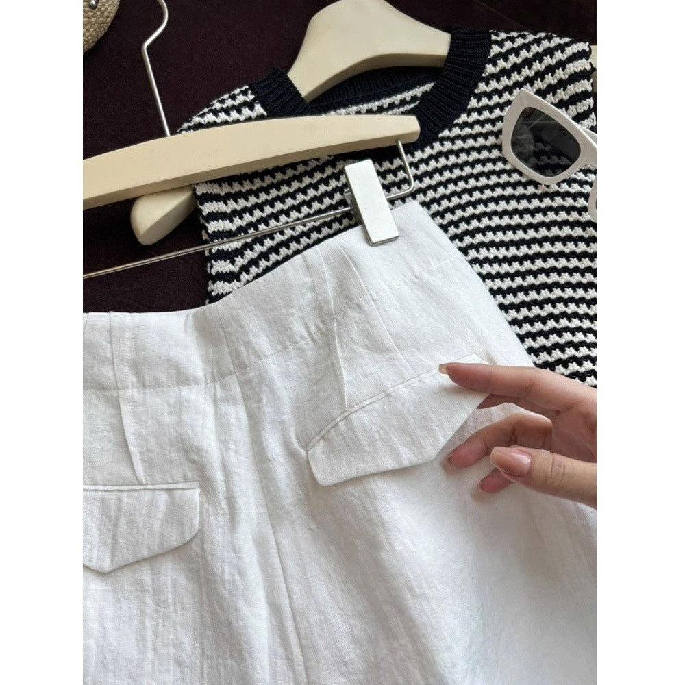Close view of white linen shorts back flap welt pocket detail