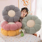 Flower shaped plush seat cushion resting on a chair with chunky knit petals