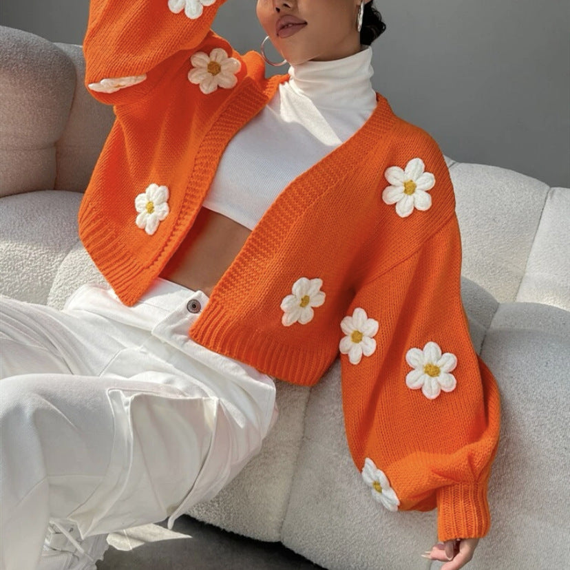 Back view of the floral lantern sleeve open front knit cardigan on a model