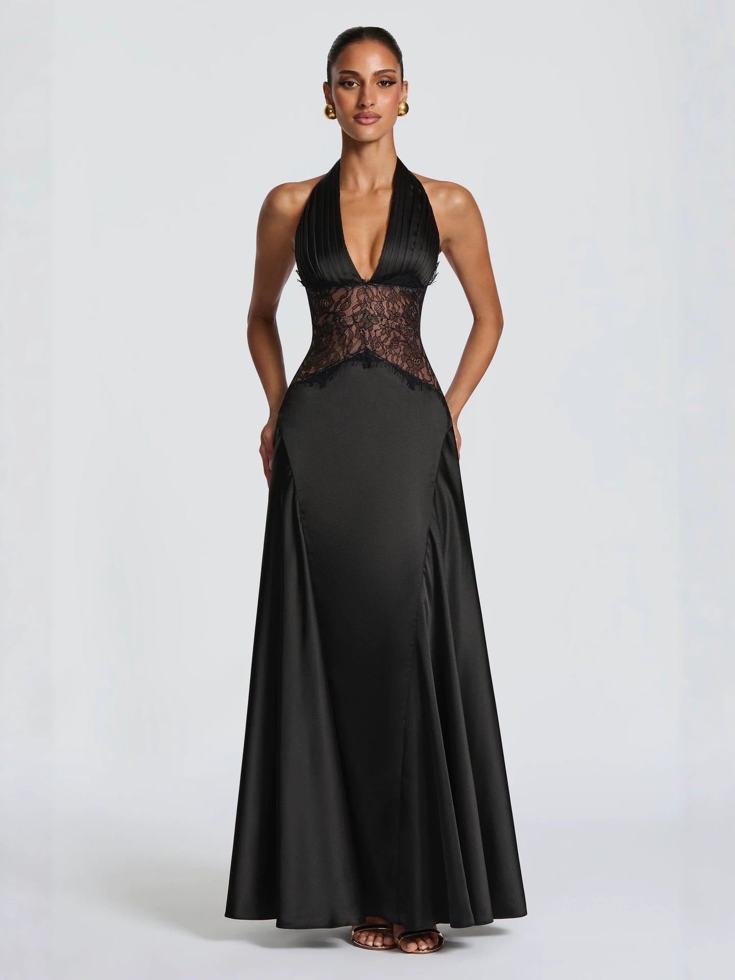 Black satin halter gown with a plunging V and sheer lace waist, front studio view