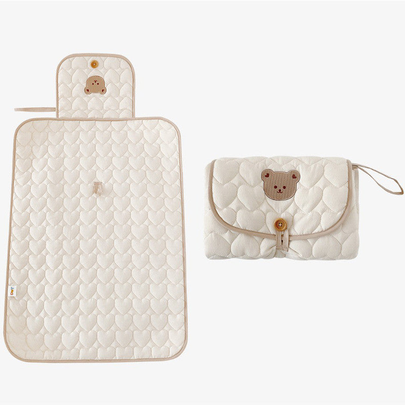 Cotton baby changing pad opened on a counter in a modern interior scene