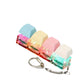Macaron pastel keycap clicker keychain lit in color on a plain white background