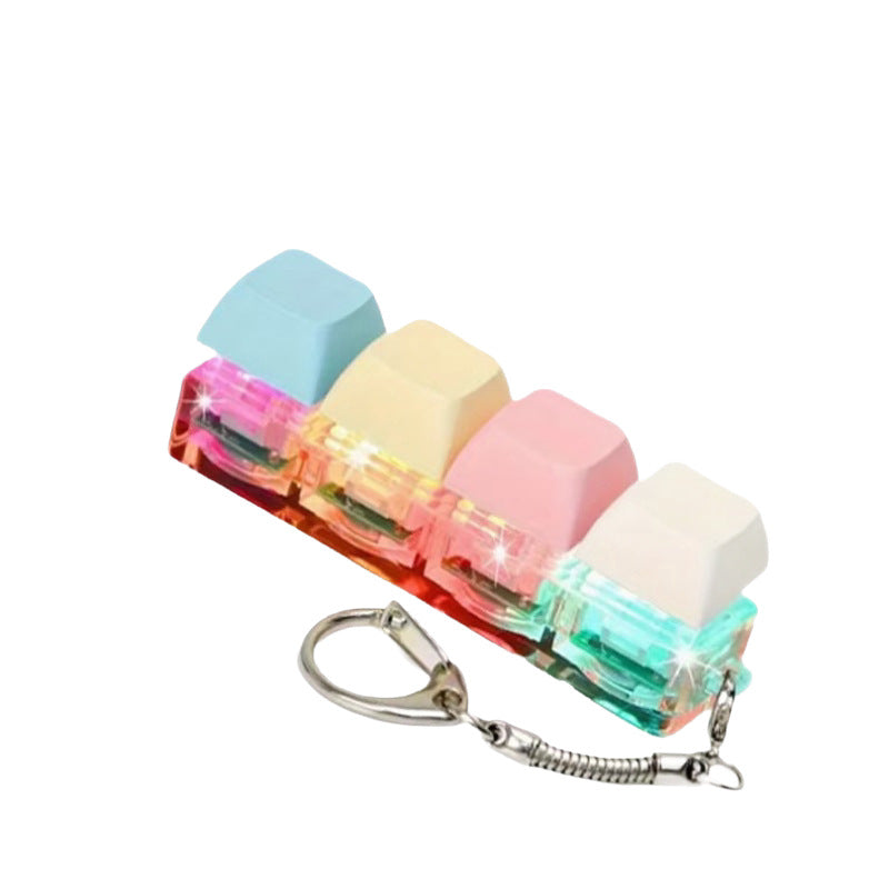 Macaron pastel keycap clicker keychain lit in color on a plain white background