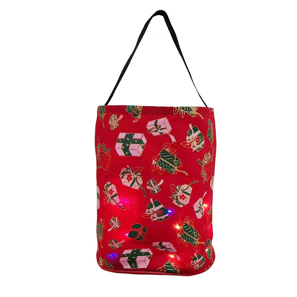 Red Christmas party bucket bag printed with green trees and glowing LED lights inside