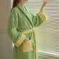 Green striped cotton terry bathrobe with yellow trim shown with the shawl collar and belt