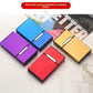 Aluminum cigarette cases in purple, blue, red, and gold finishes on a marble surface