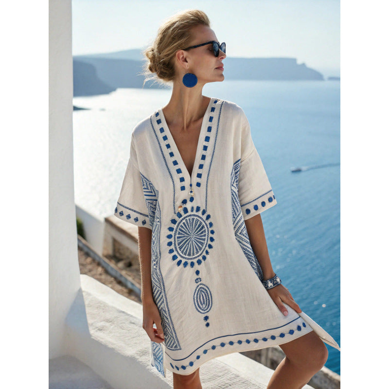 Loose V neck bohemian beach cover up dress in a bohemian border print, worn on a bright beach morning