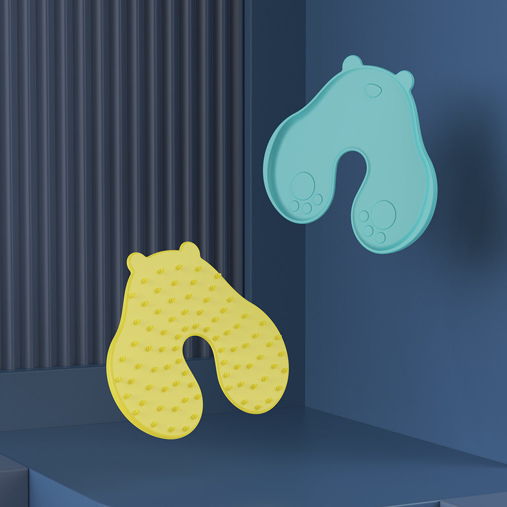 Mint green and yellow bear shaped skin pads, one textured face and one smooth face with paw prints