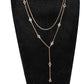 Close view of a gold double layer rhinestone necklace and its slim Y drop