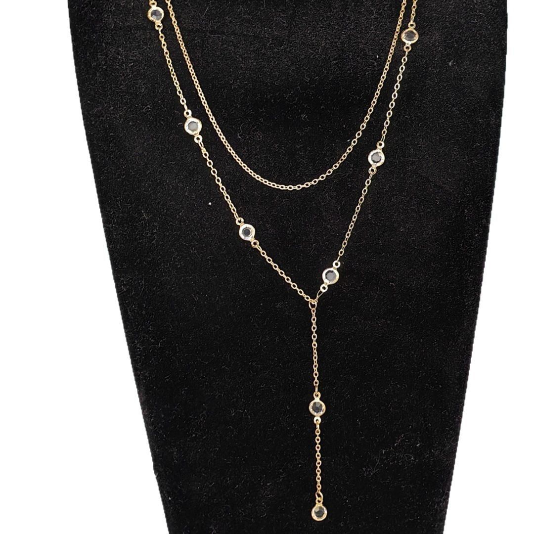 Close view of a gold double layer rhinestone necklace and its slim Y drop