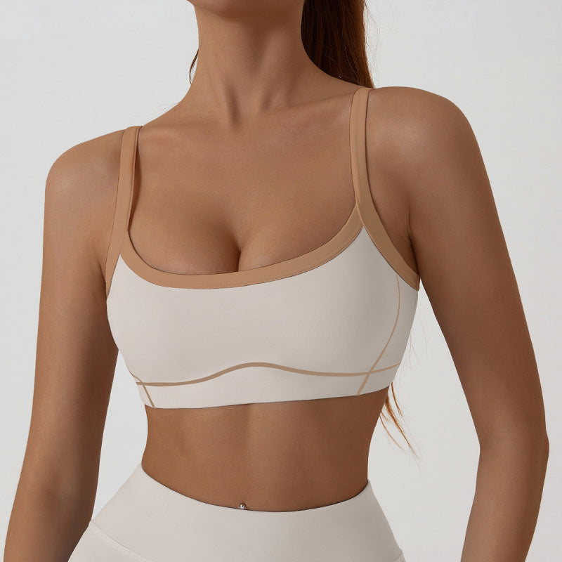 Close view of the contrast piping tracing the bust seams of the strappy sports bra
