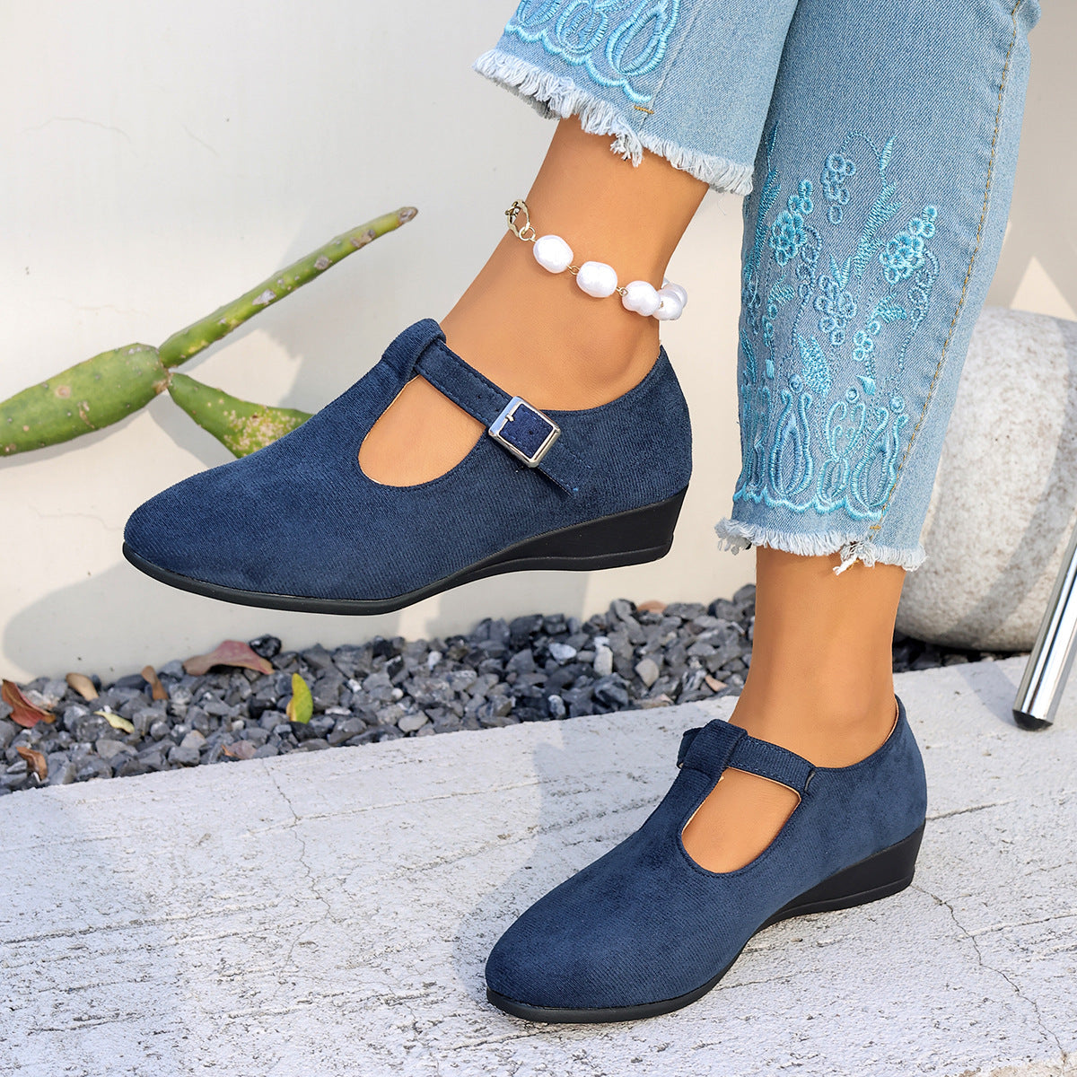 Womens closed toe faux suede low wedge shoe with criss cross elastic strap over the instep