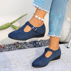 Womens closed toe faux suede low wedge shoe with criss cross elastic strap over the instep