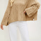Loose round neck twist cable knit sweater with wide flared long sleeves on a model
