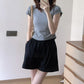 Black ice silk wide leg shorts worn with a gray tee showing the smocked elastic waist
