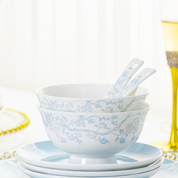 Stacked plum blossom porcelain bowls with two serving spoons