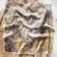 Grey and gold marble printed square scarf with a satin sheen and hemmed edges, shown displayed