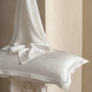 Ivory Wave jacquard silk pillowcase with white silk draped over it, single pillowcase option