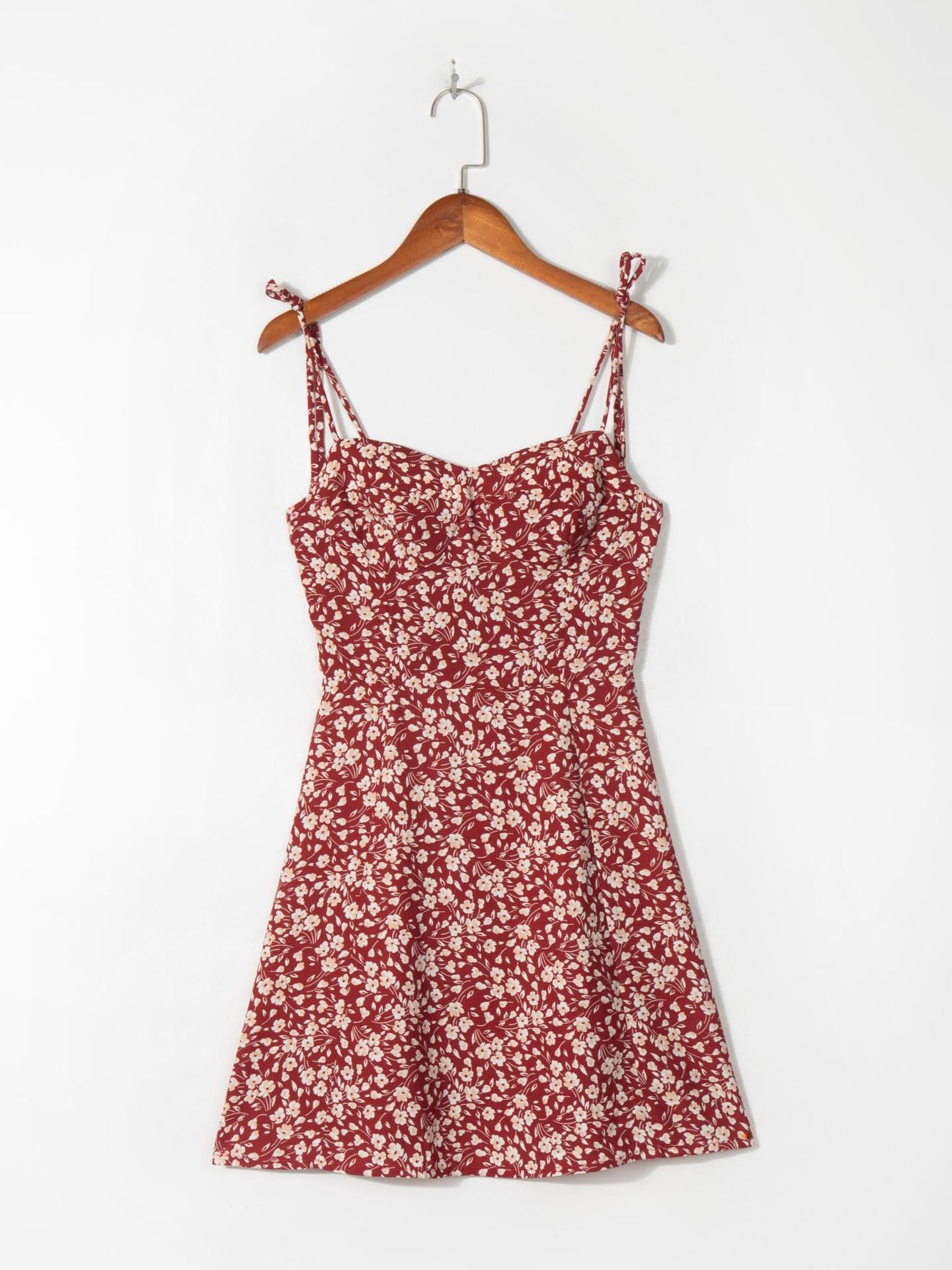 Full length view of the short wine red floral strap dress hanging flat