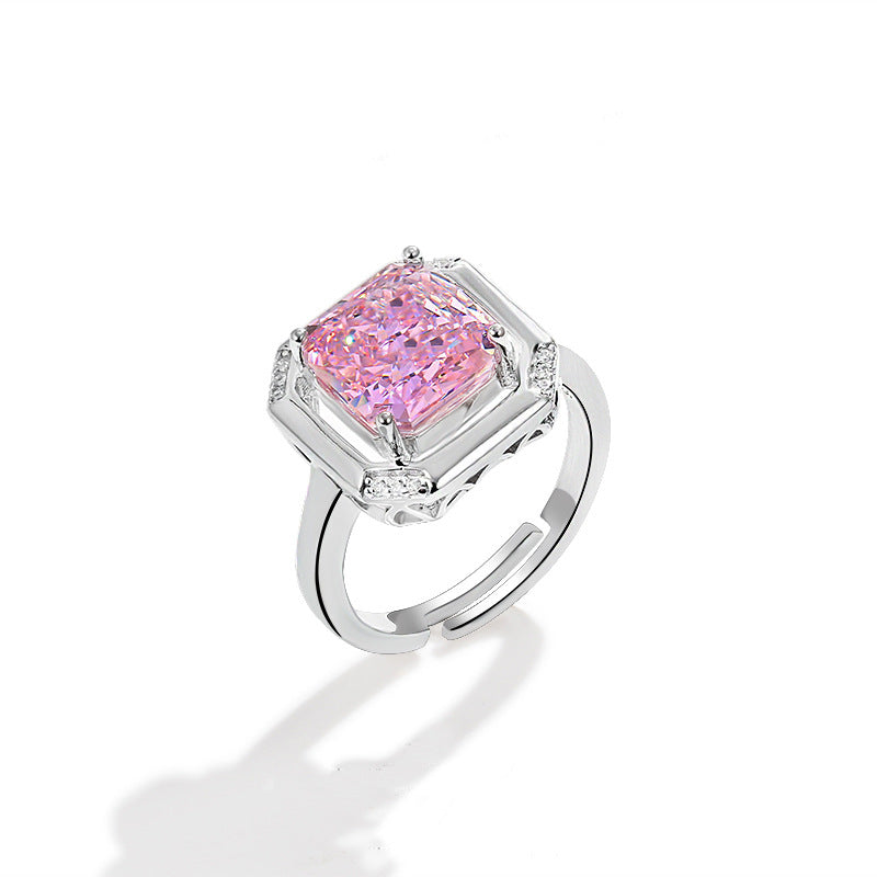 Pink radiant stone set in an open square frame on a split adjustable band, side view on white