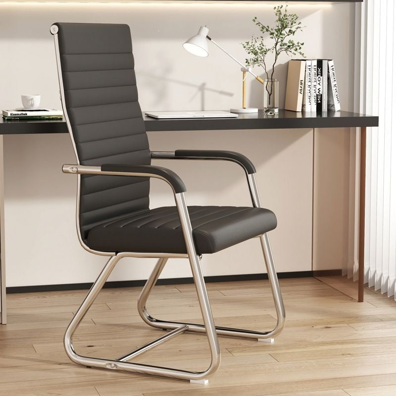 High back black leather cantilever conference chair, foam seat, fixed armrests and chrome frame in an office
