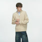 Beige khaki half zip cable knit sweater over a light blue shirt on a male model looking down, fourth khaki option photo