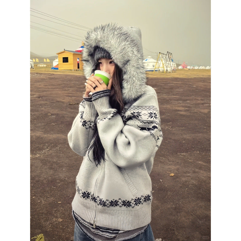 Grey Fair Isle knit cardigan with faux fur hood up and a side pocket, woman holding a cup near her face
