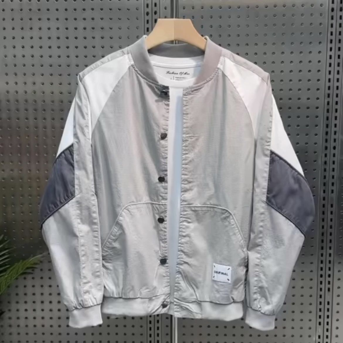 Thin baseball collar jacket side profile showing ribbed cuff and sleeve