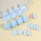 Velvet triangle powder puffs and round puffs beside teardrop foam makeup sponges